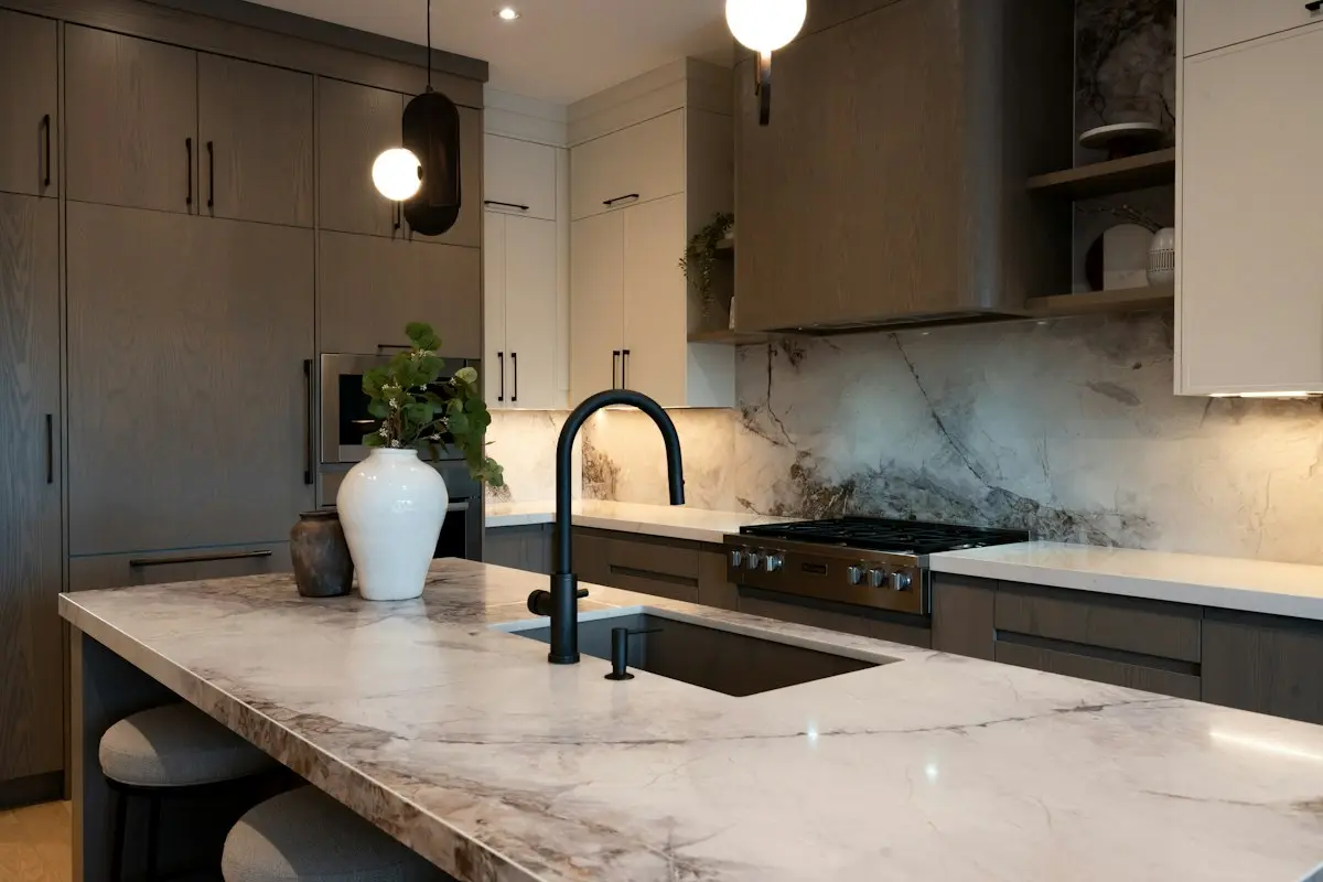 Kitchen with a stone island and dark tap