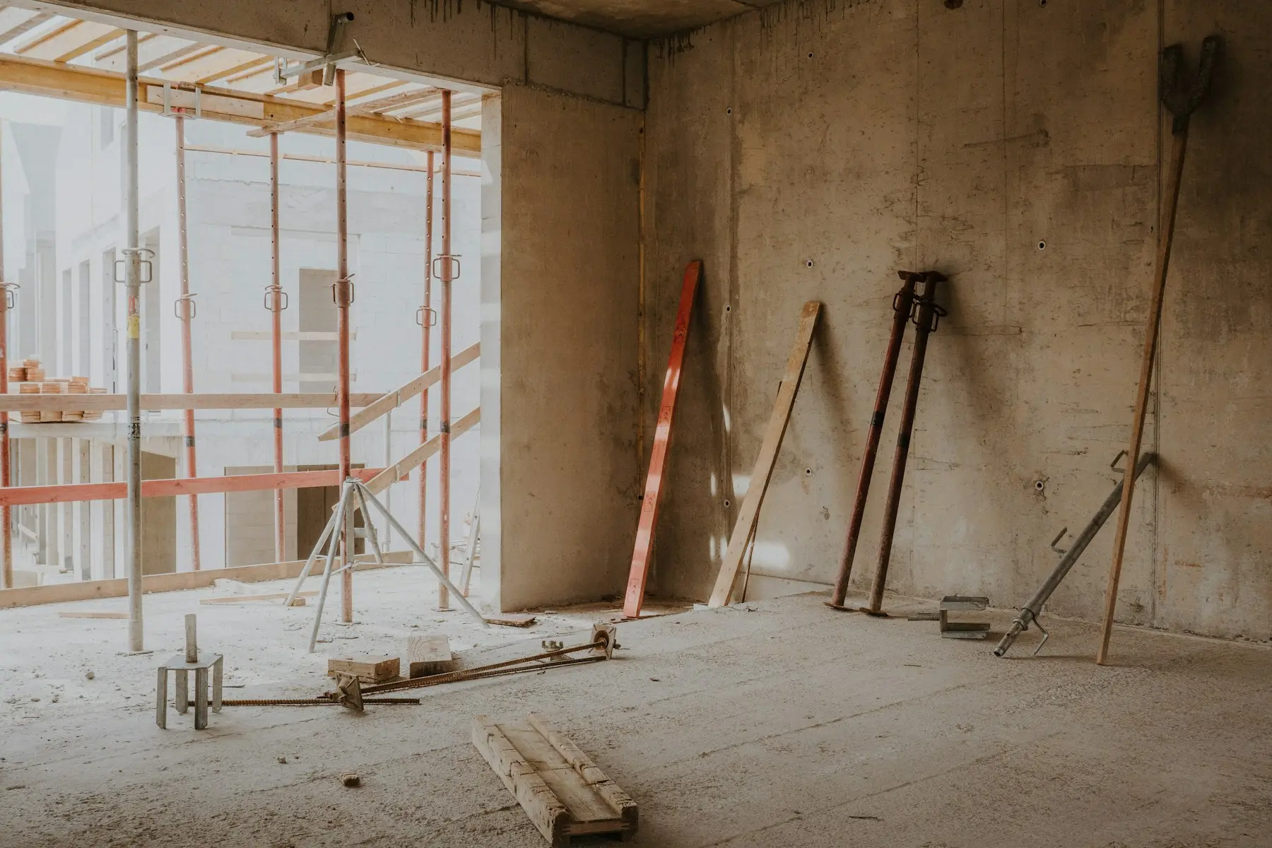 Room stripped back to bare block walls with props in place