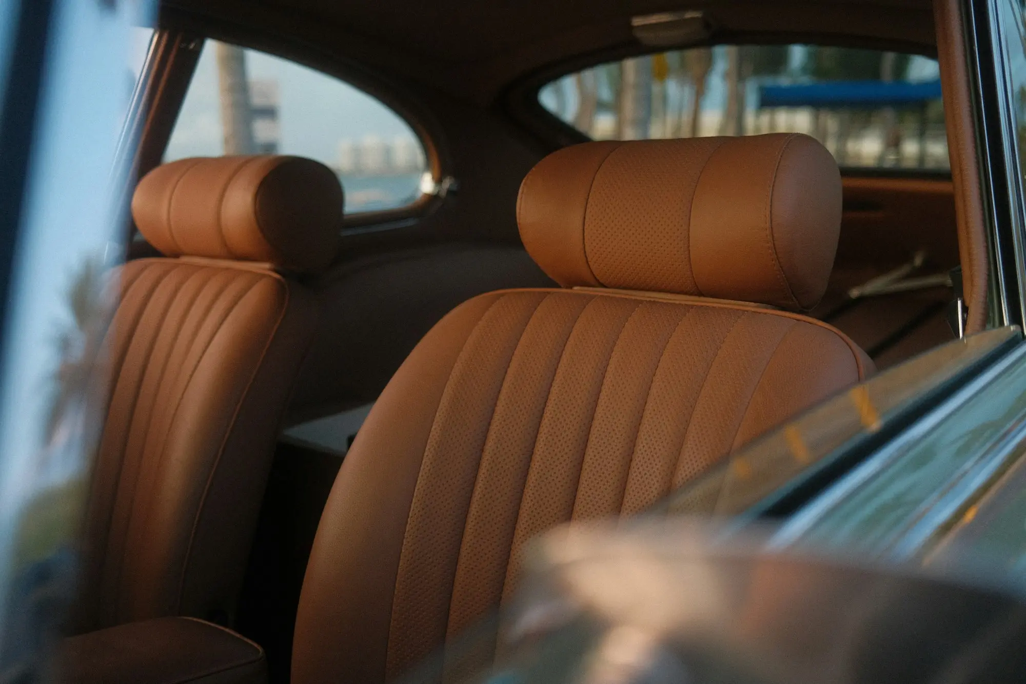 Tan leather cabin of a classic grand tourer