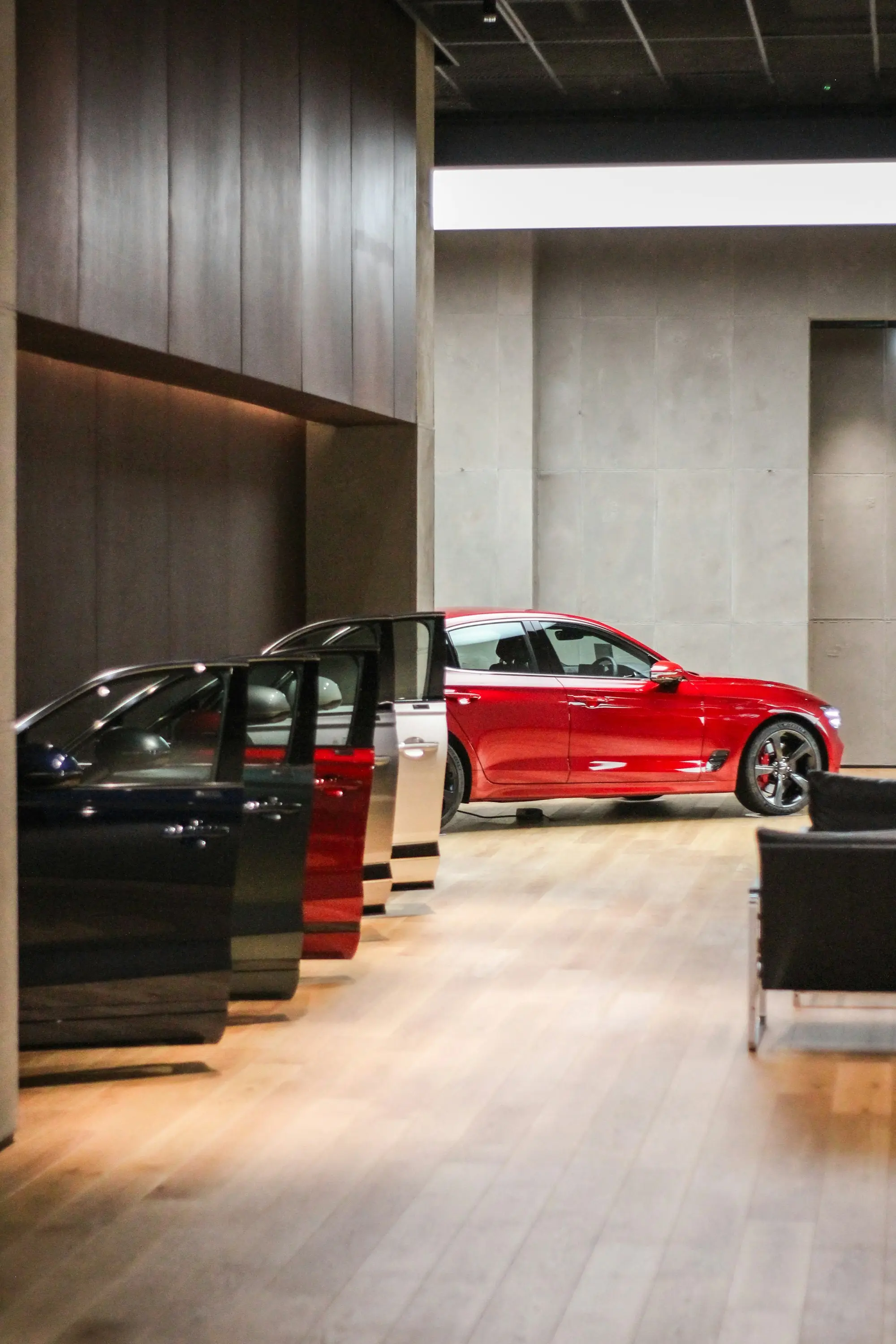 Showroom floor with cars lined up, doors open