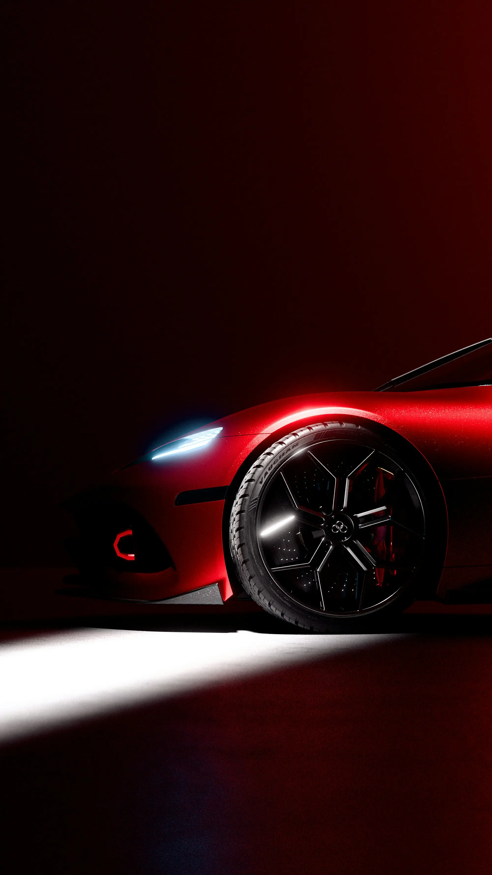 Red sports coupe under a single beam of light