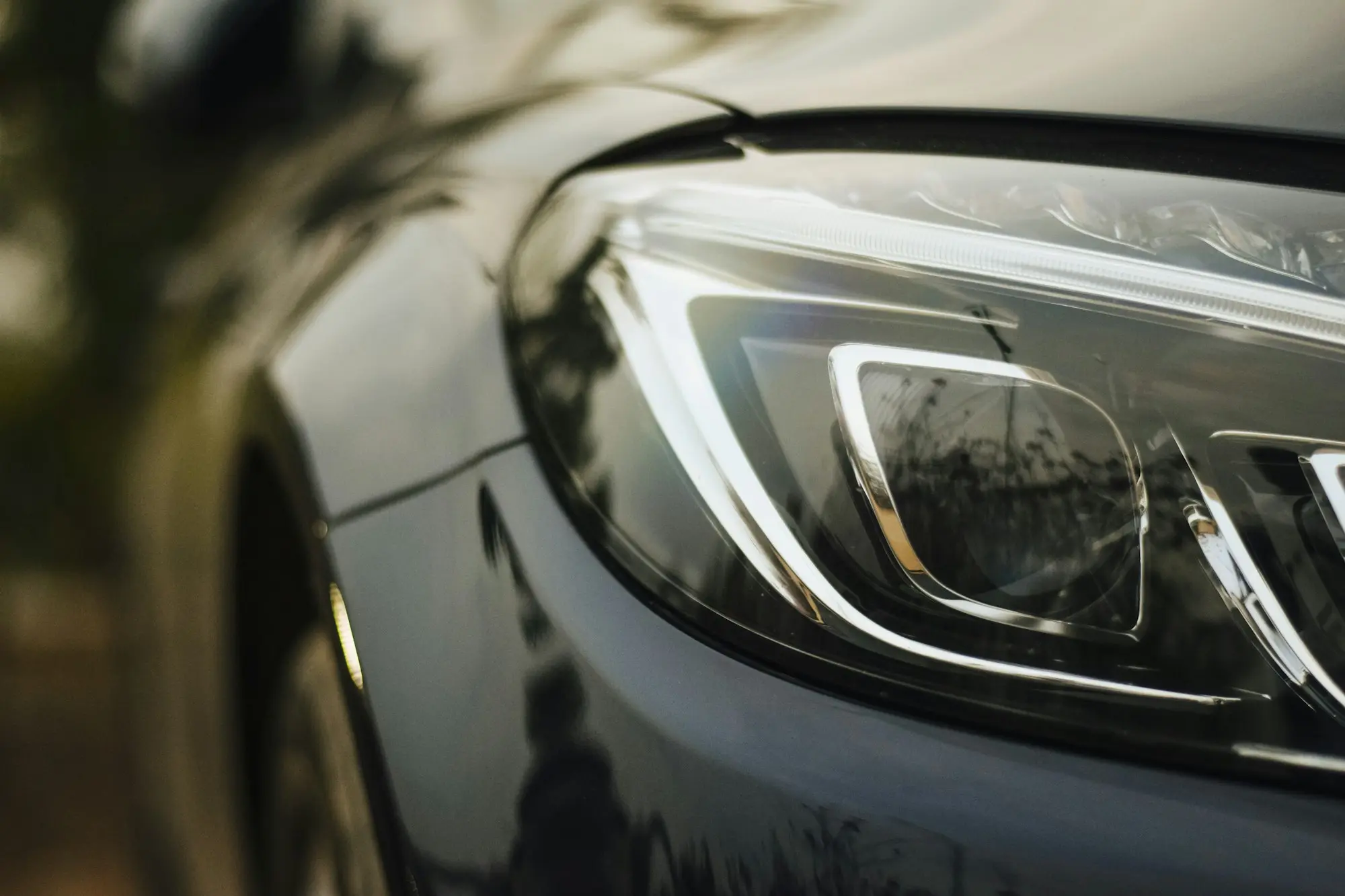 Close up of an LED headlight on a grey saloon