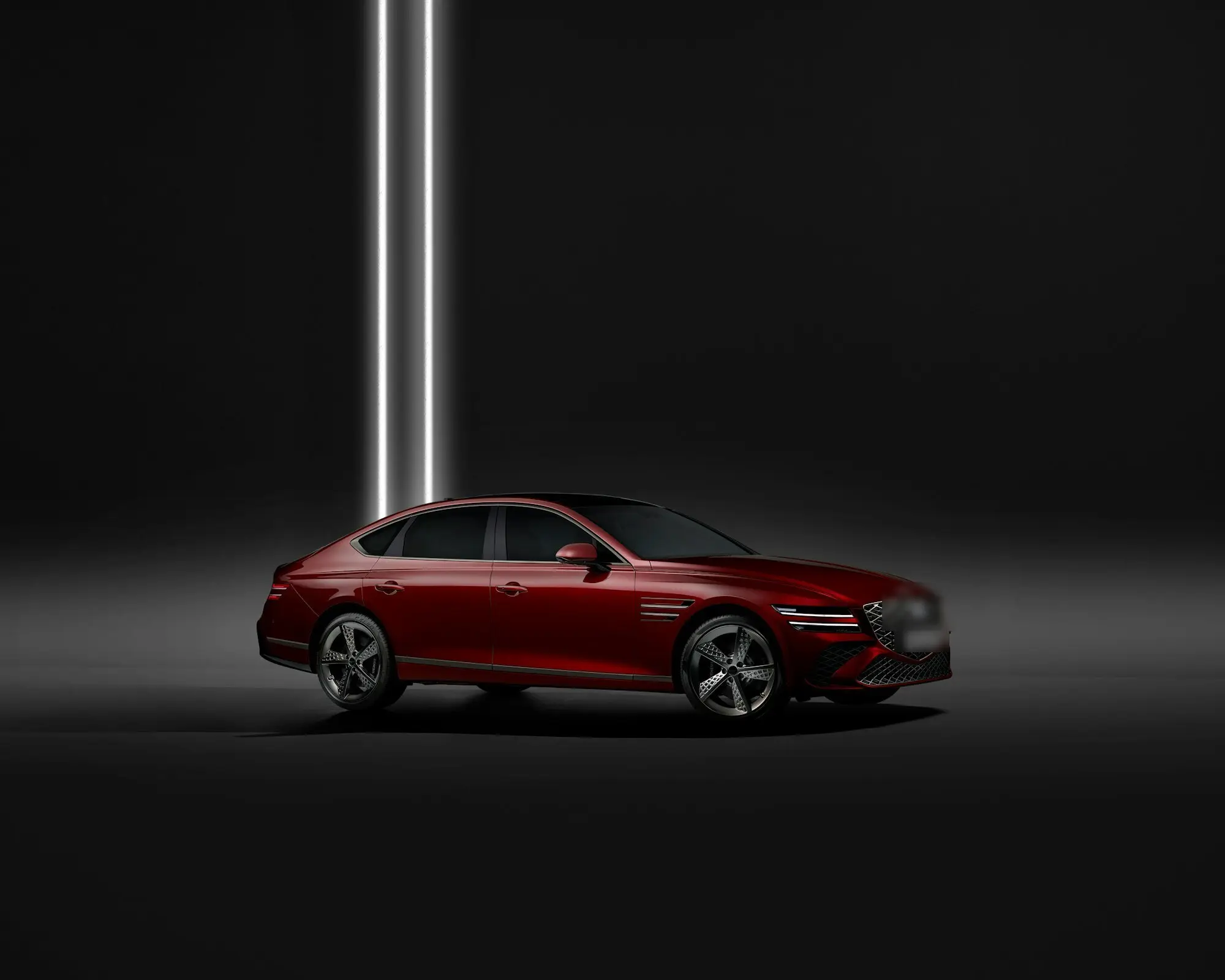 Red luxury saloon in a dark studio