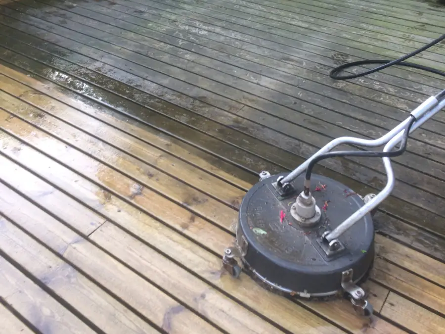 Decking being cleaned with a rotary surface cleaner