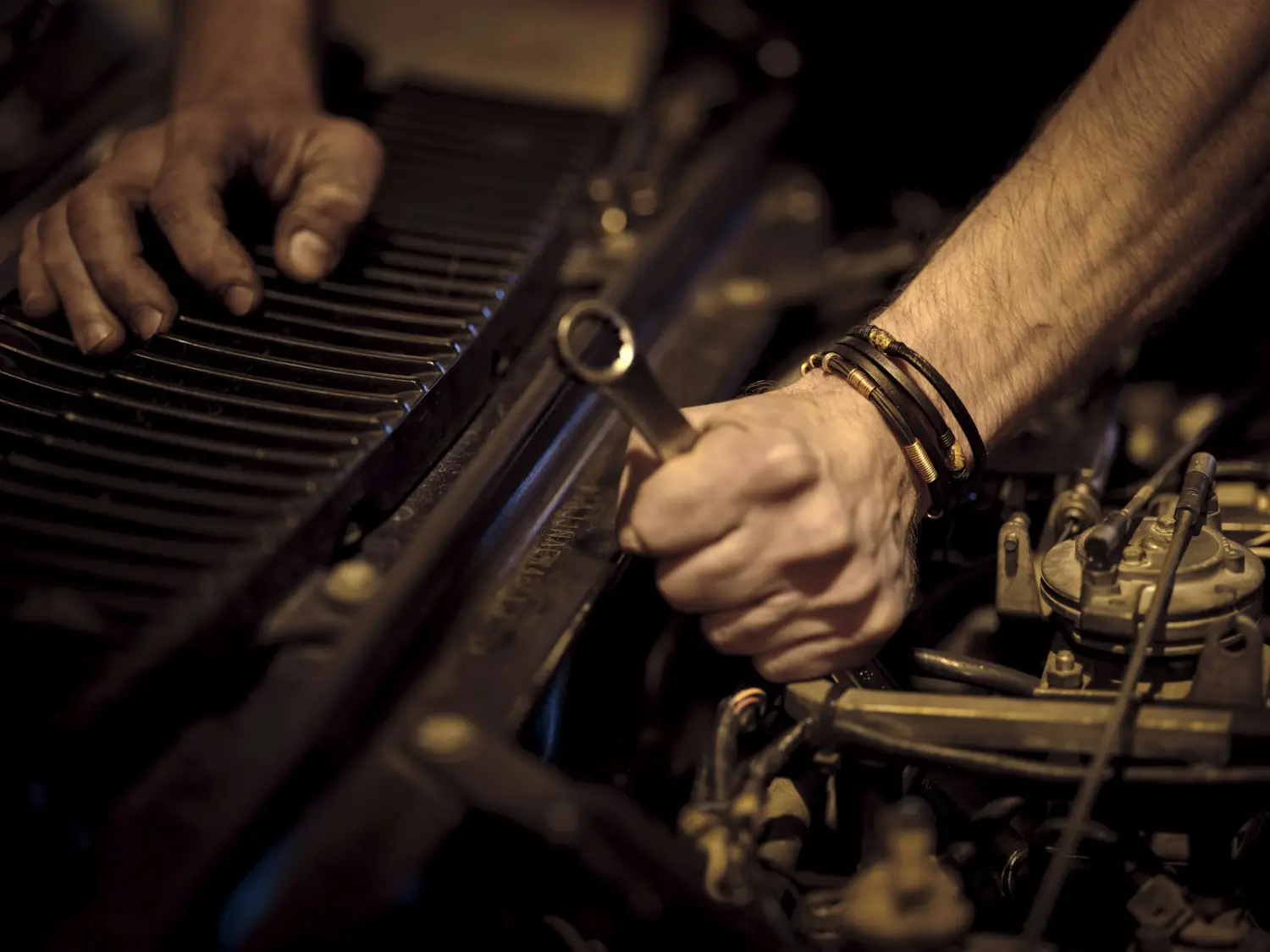 Mechanic tightening a part with a spanner
