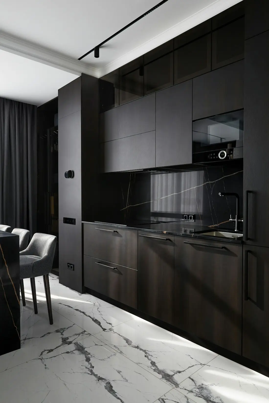 Dark timber kitchen with a marble splashback
