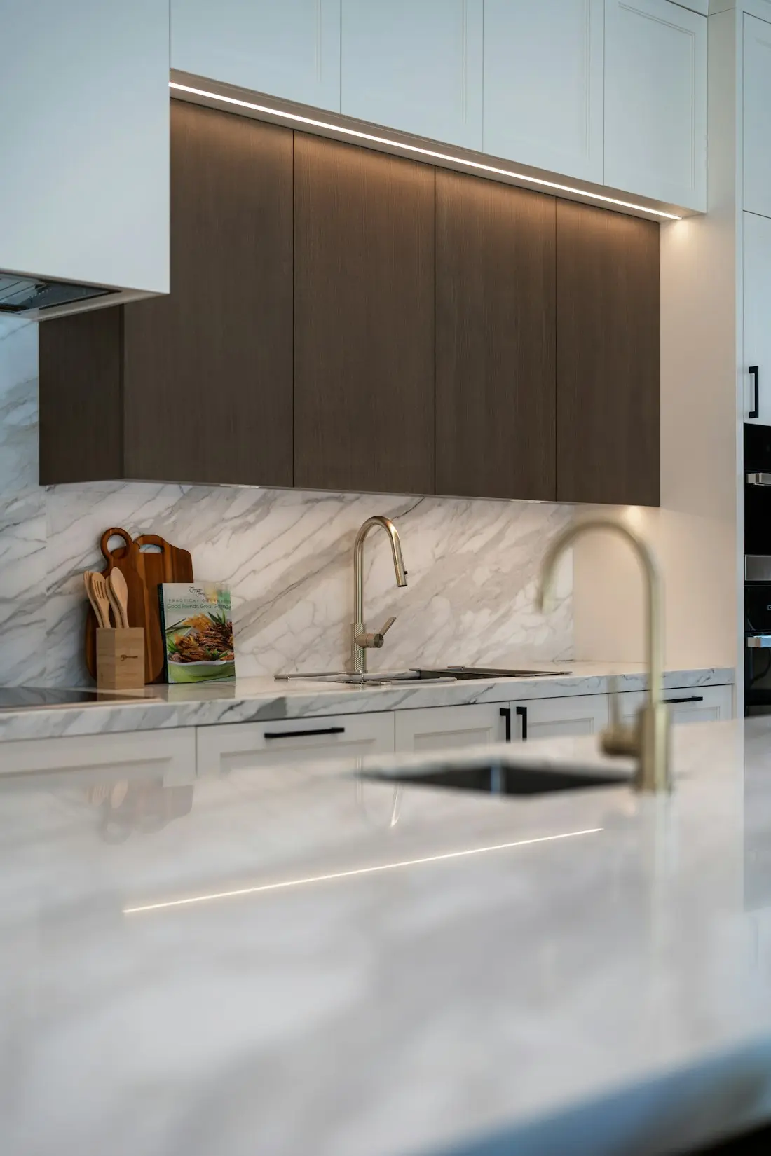 Brushed brass taps over a marble worktop
