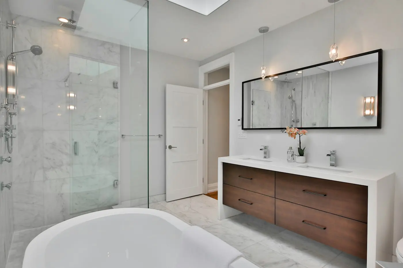 Bathroom with freestanding bath and walnut vanity