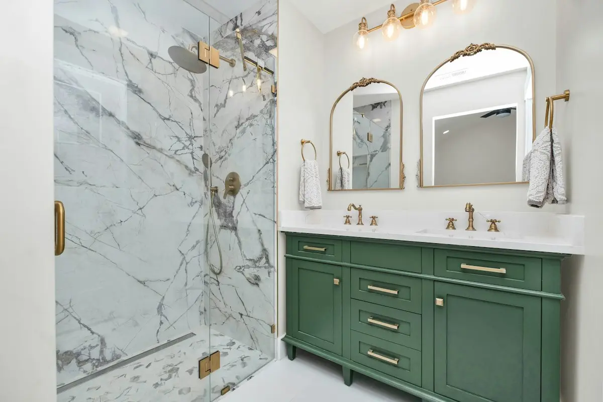 Marble bathroom with a green vanity