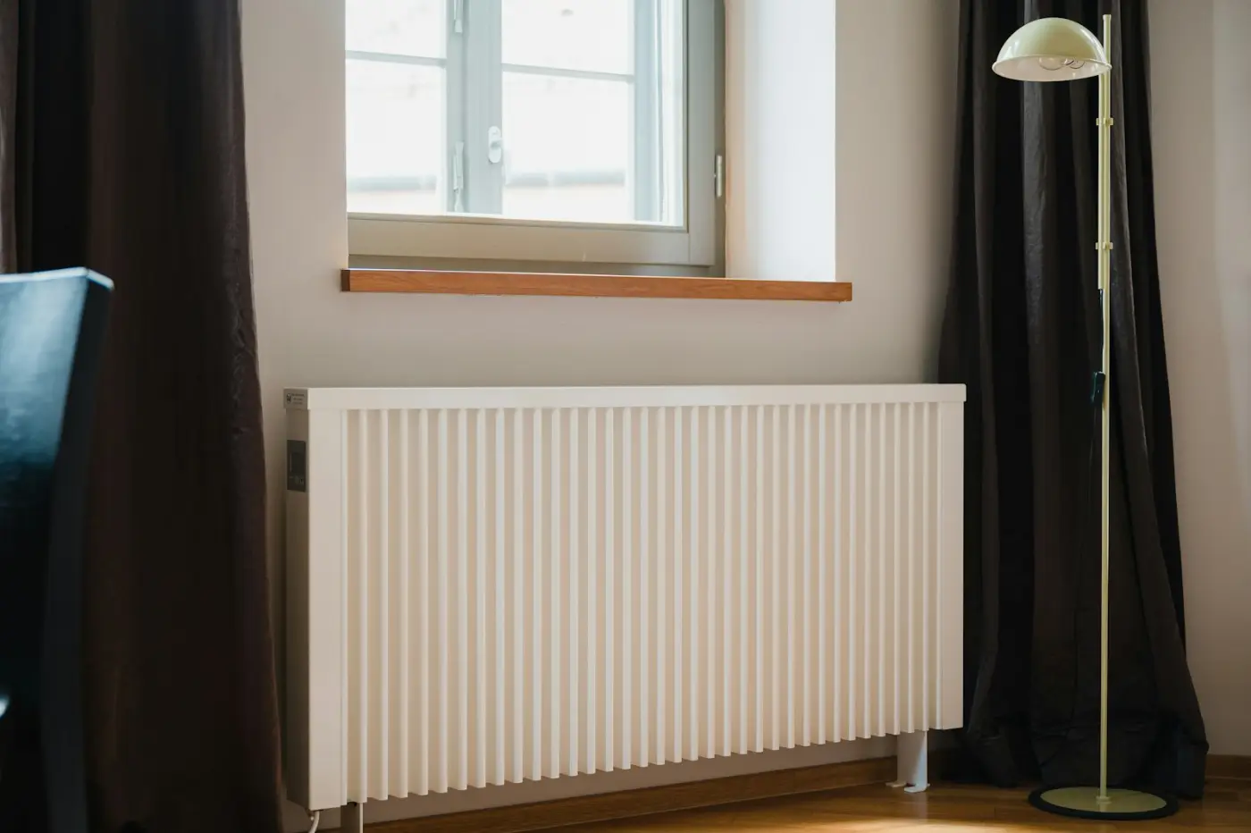 Freshly fitted white radiator under a window