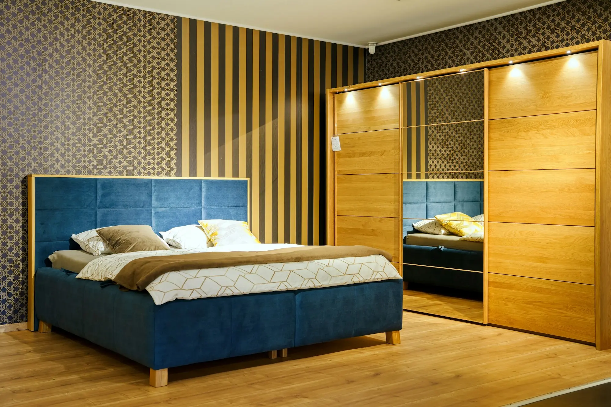 Blue upholstered bed and oak wardrobe